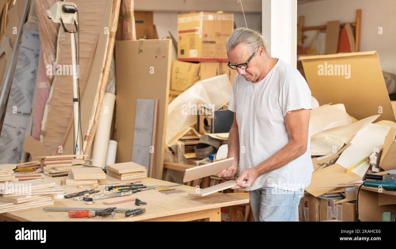 Carpenter working on wood craft at producing wooden furniture