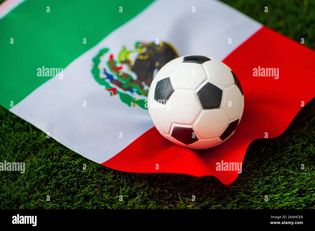 Mexico national football team. National Flag on green grass and soccer ball. Football wallpaper for Championship and Tournament in 2022. World interna Stock Photo