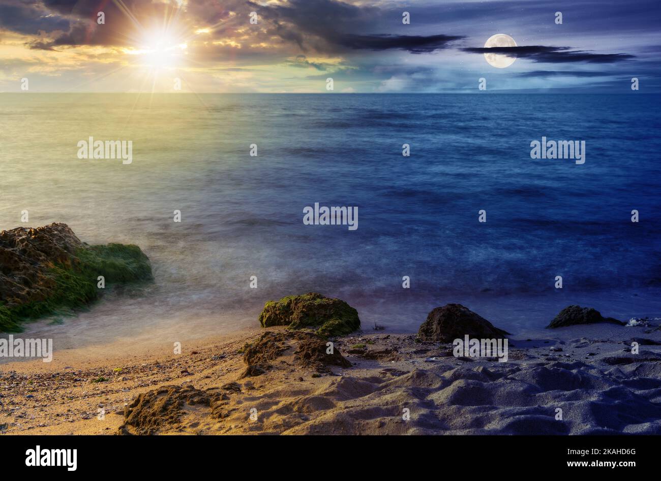 minimalistic seascape in summer at twilight. beach sea and horizon beneath a sun and moon. day and night time change concept. purity in nature Stock Photo
