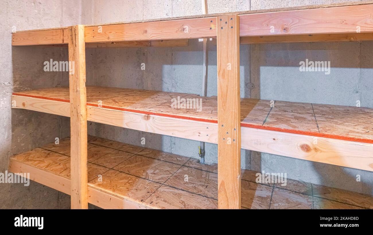 Panorama Unfinished small storage room with concrete walls and wooden