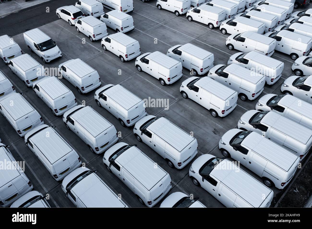 DONCASTER, UK OCTOBER 13, 2022. An aerial view directly above rows of new white vans at a