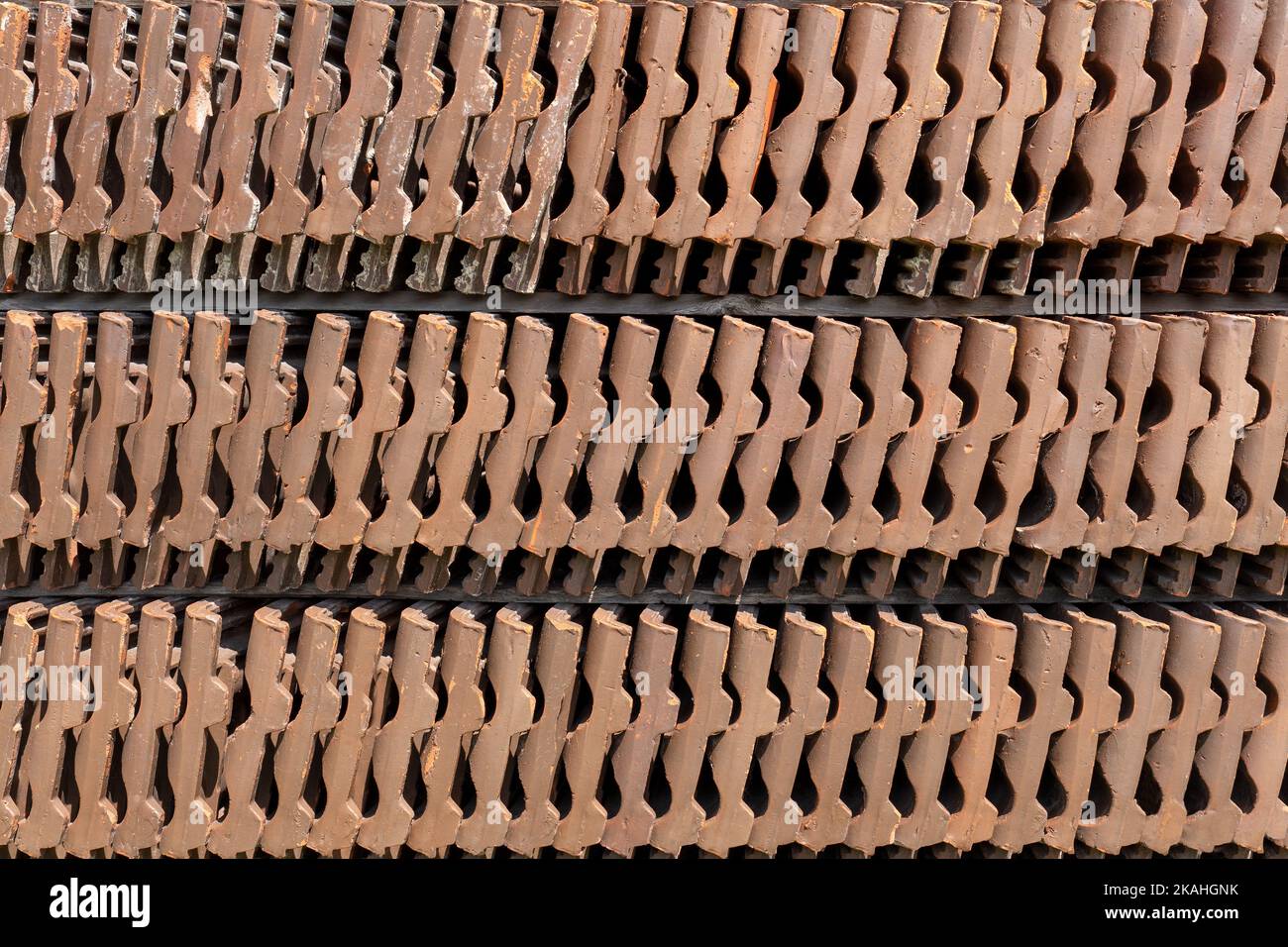 Three rows of upright old roof tiles in close-up Stock Photo