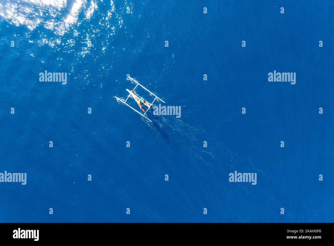 Aerial view of a traditional fishing boat sailing in ocean, Lombok, West Nusa Tenggara, Indonesia Stock Photo