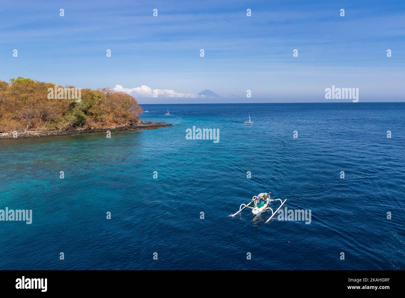 Traditional fishing boat sailing along coastline, Lombok, West Nusa Tenggara, Indonesia Stock Photo