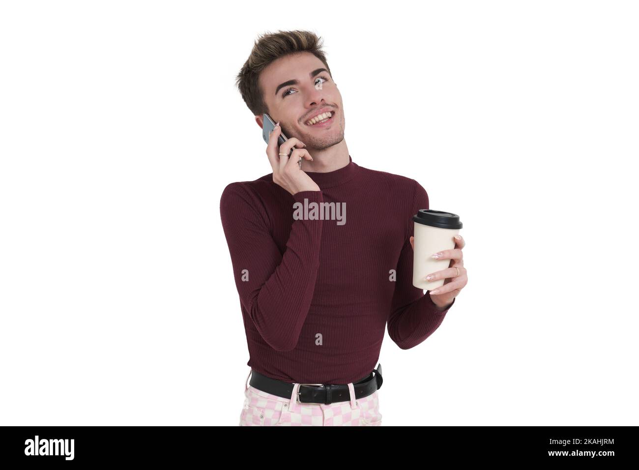 Young caucasian man smile speaking on the phone with a coffee cup, isolated. Stock Photo