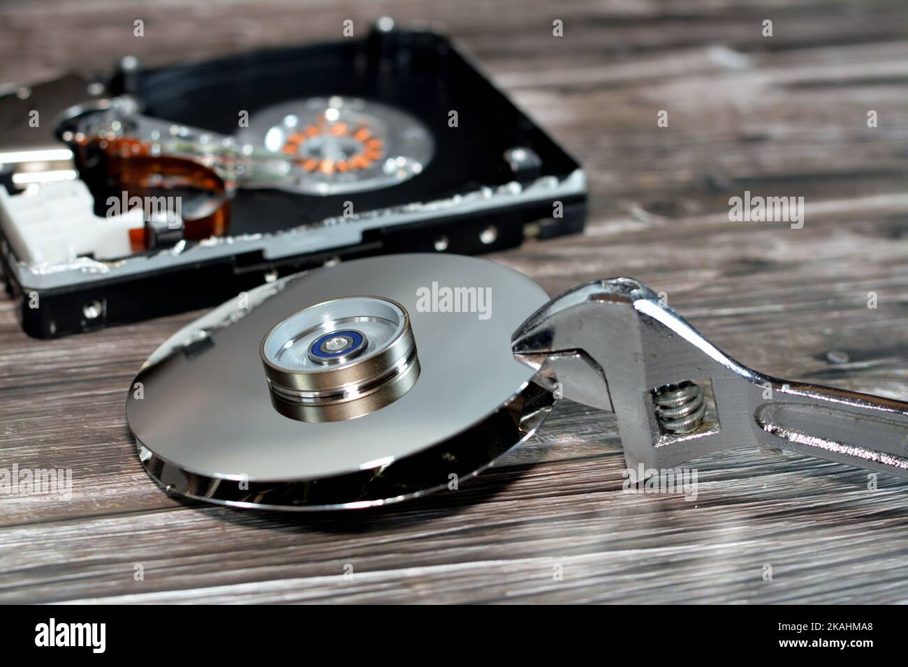An adjustable spanner wrench and HDD platters together, hard disk drive