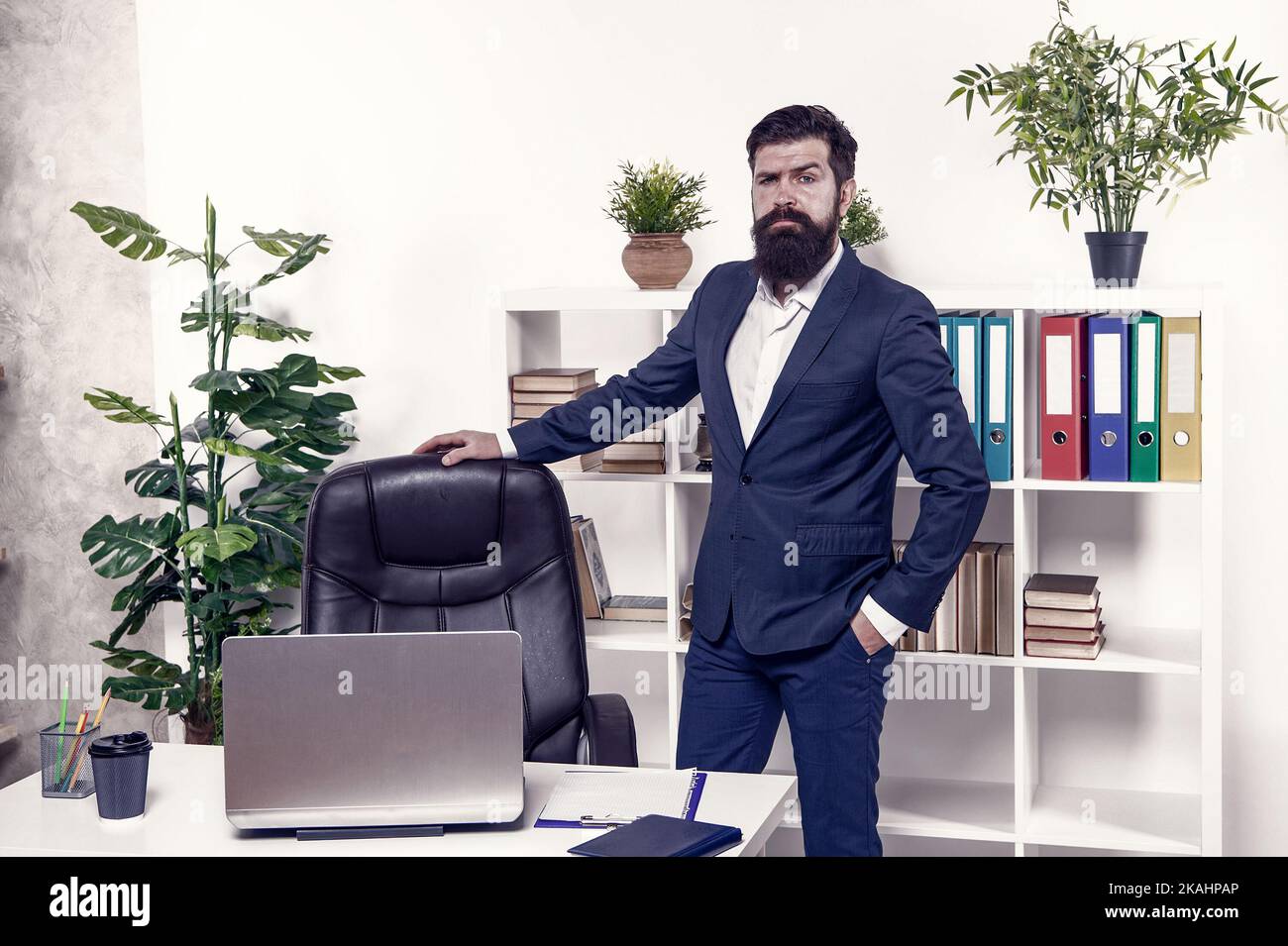 Vacant position. Human resource manager in office. Interviewer welcome job candidate. Man having job interview in company HR department. Empty chair Stock Photo
