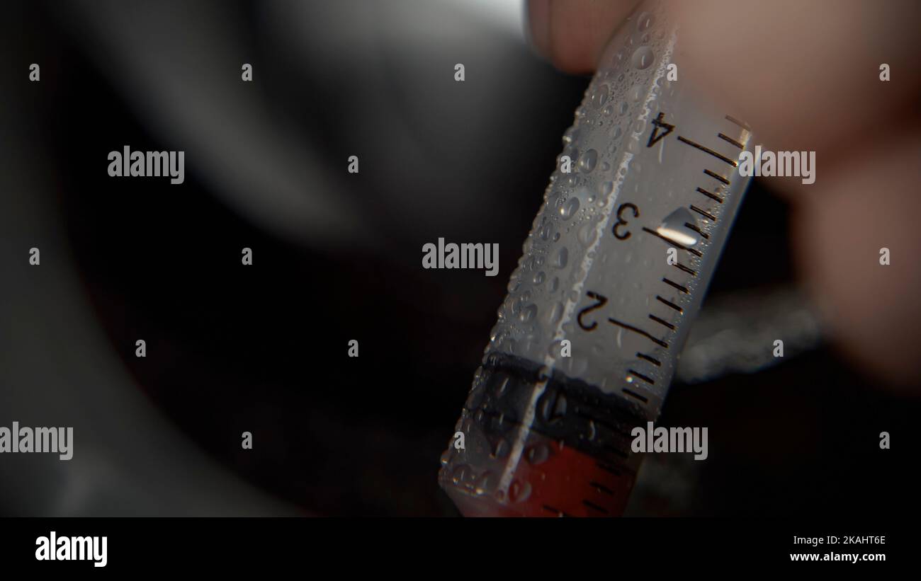 Syringe with blood filling in extra closeup, taking medical blood
