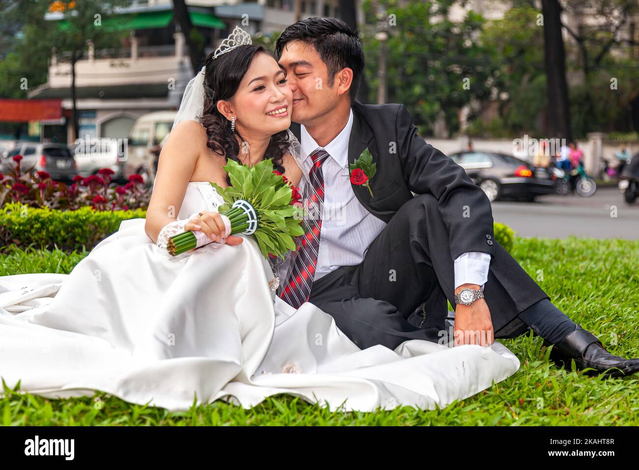 Vietnamese bride and groom posing for wedding portrait in public park, Ho Chi Minh City, Vietnam Stock Photo