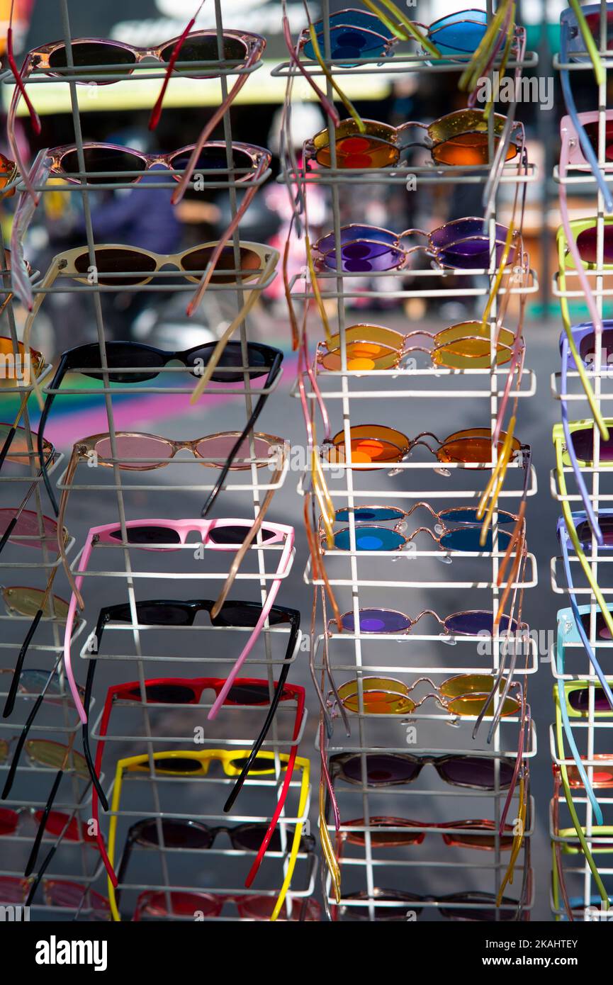 pairs of sunglasses for sale on a market stall Stock Photo Alamy