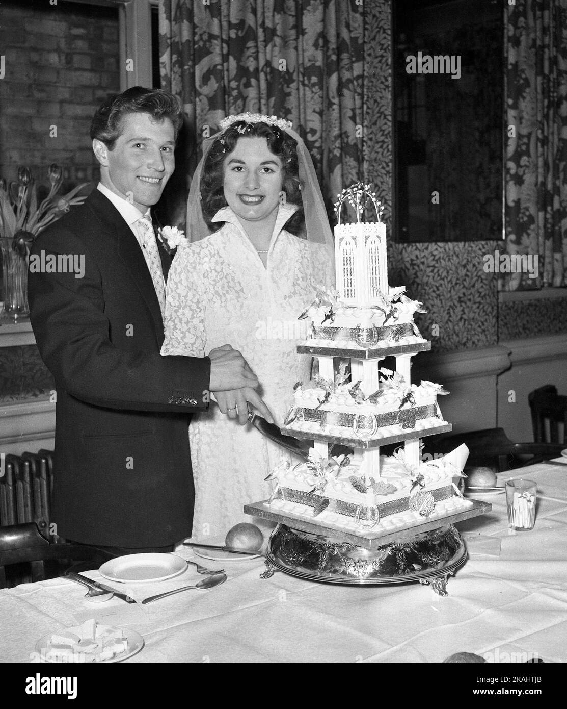 Wedding Day of Mr & Mrs Francis of 23 Myrtle Road, London E17 c1952 The happy couple and the cutting of the cake at the reception  Photo by Tony Henshaw Archive Stock Photo