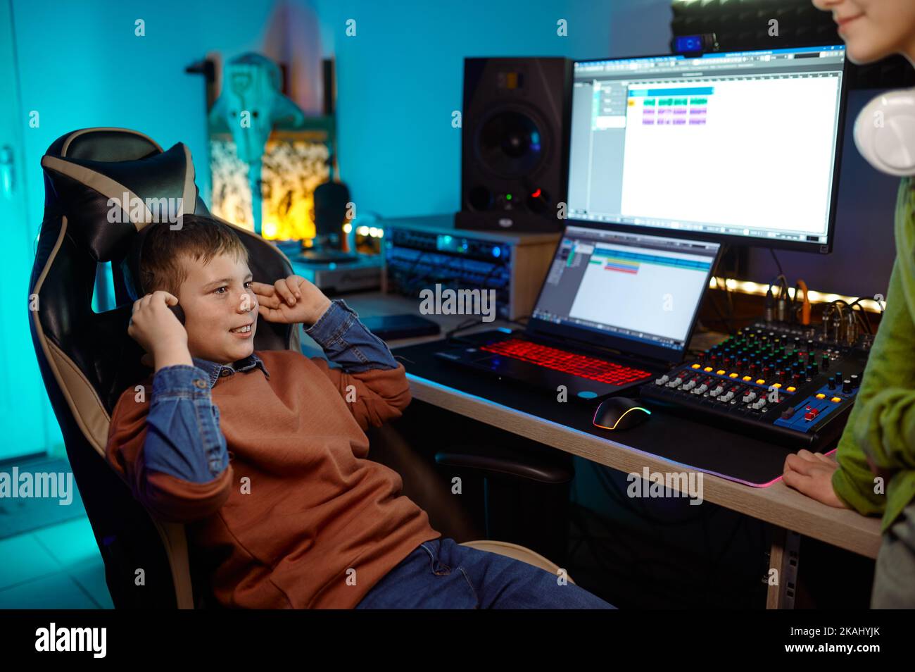Children at recording studio boy listening new soundtrack Stock Photo