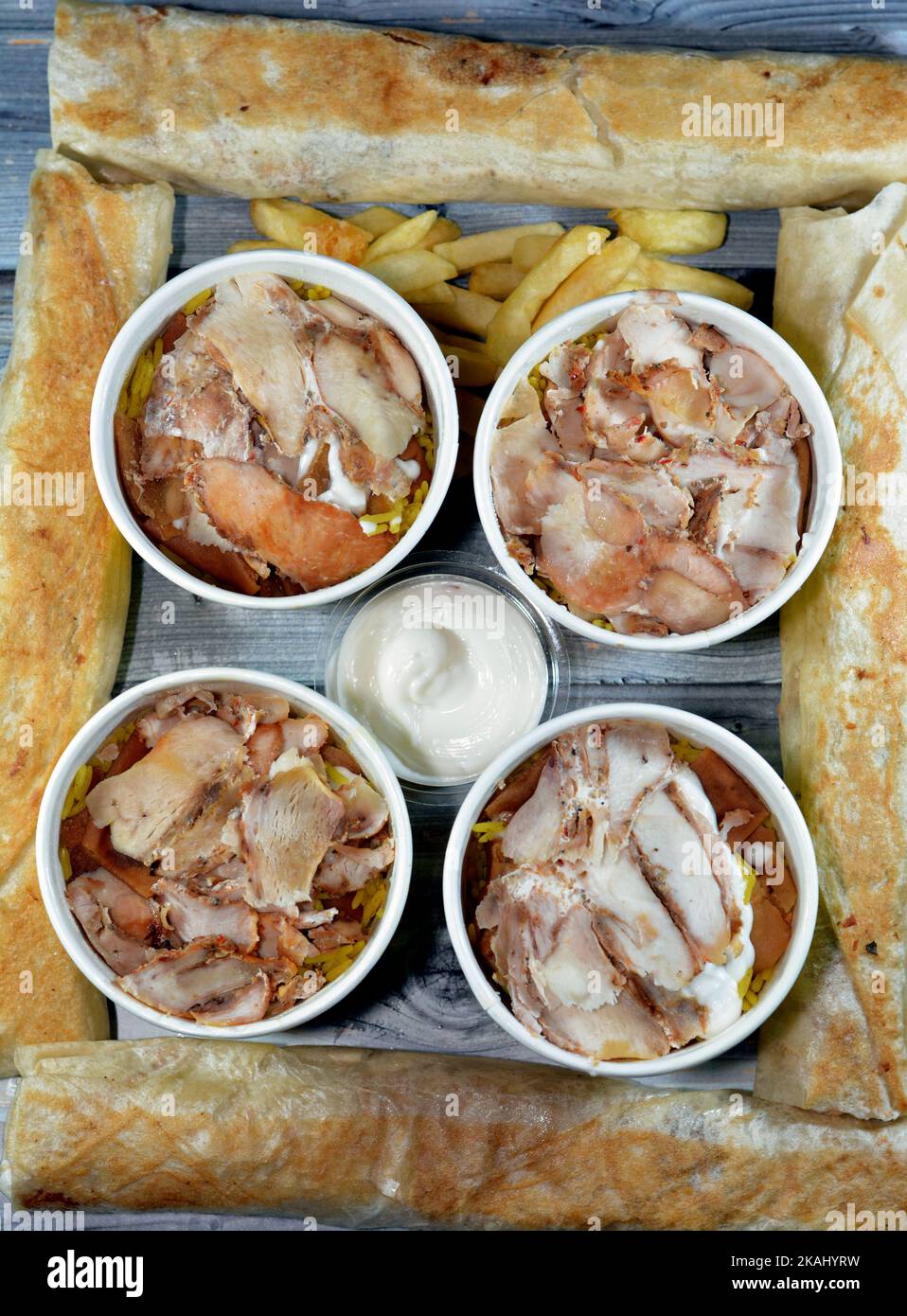 Pieces of Chicken shawarma and yellow Basmati rice, Syrian bread and