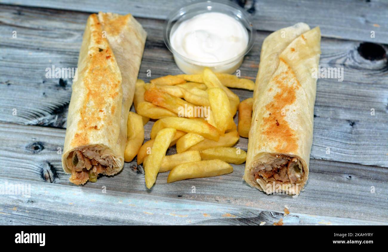 Syrian recipe cuisine background, chicken shawerma or shawarma tortilla