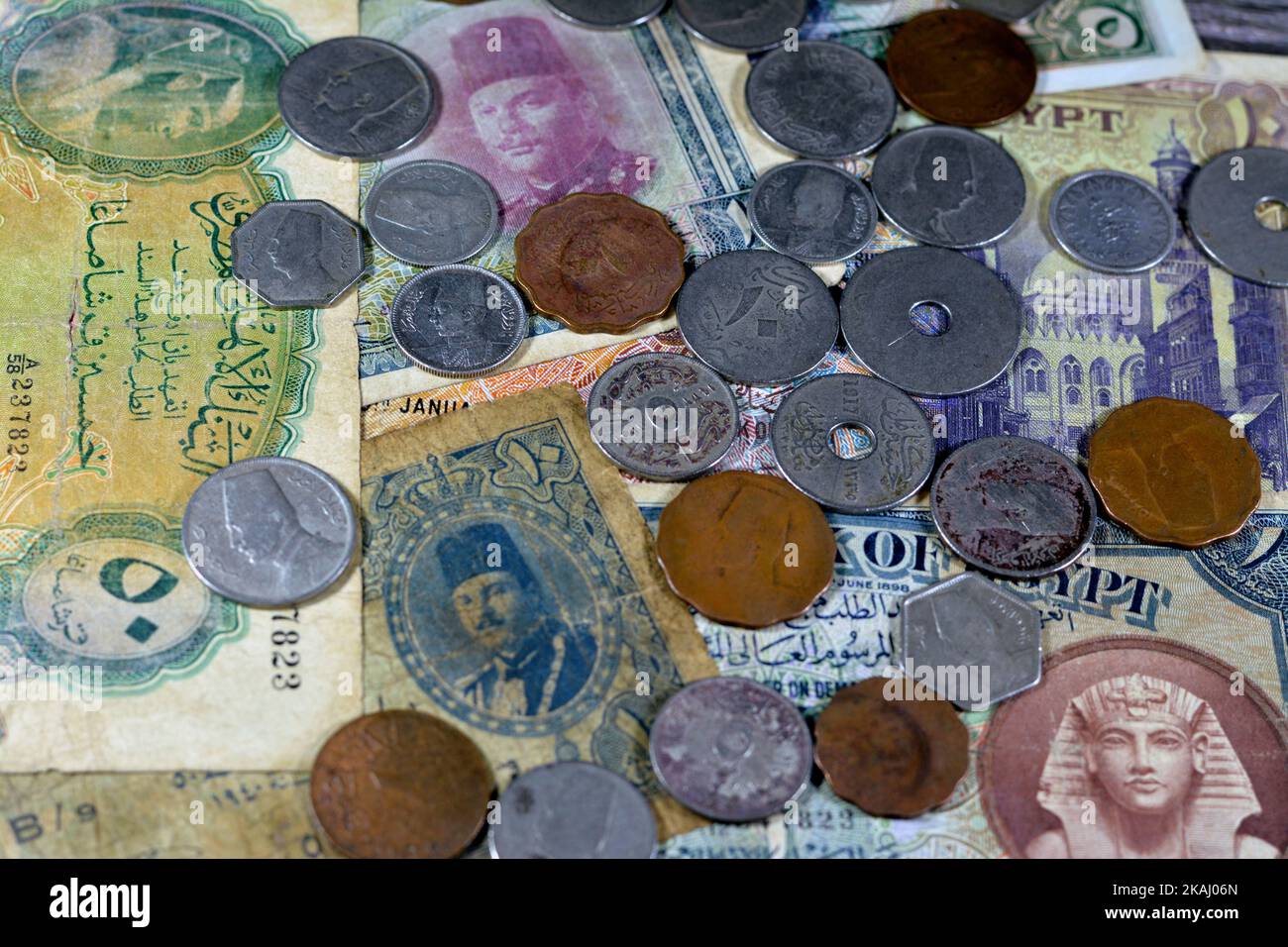 Background of old Egyptian coins and paper banknotes cash money from