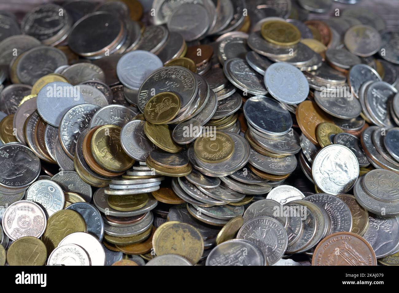 Pile of old coins of different values from different countries of the ...