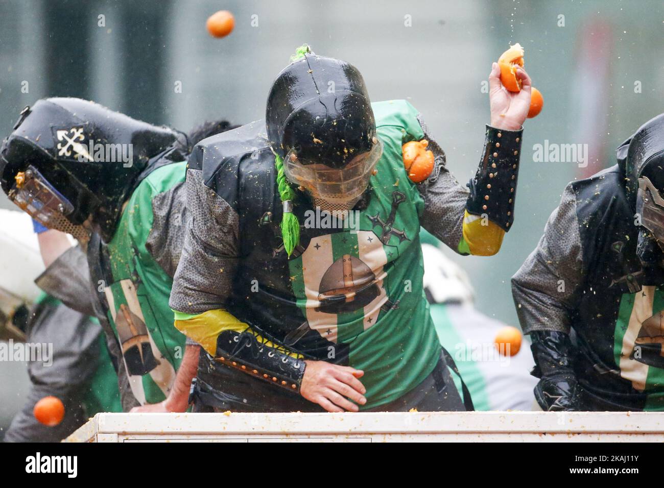 orange throwers on horsedrawn carts hit by the oranges throwed by