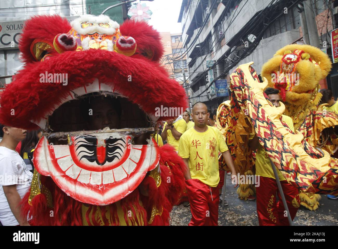 Lion dancers walk in the streets of Binondo Manila, Philippines on Chinese New Year, February 8, 2016.  A holiday in the Philippines, people celebrate the New Year in Binondo eating in authentic Chinese restaurants, buying lucky charms and watching dragon and lion dance as they welcome the Year of the Monkey. (Photo by Marlo Cueto/NurPhoto) *** Please Use Credit from Credit Field *** Stock Photo
