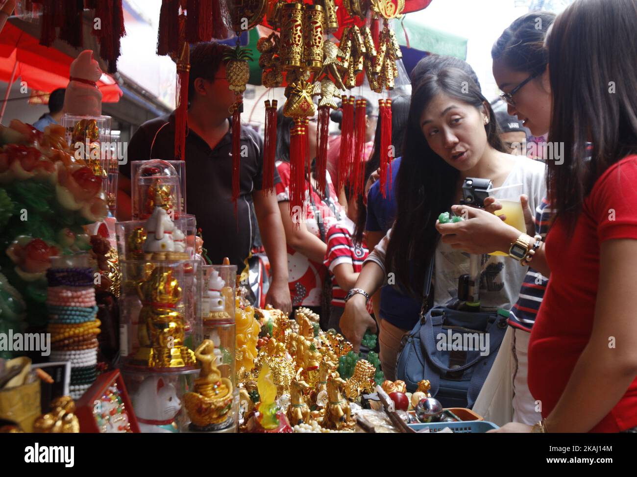 Locals buy good luck charms in Binondo Manila, Philippines on Chinese New Year, February 8, 2016.  A holiday in the Philippines, people celebrate the New Year in Binondo eating in authentic Chinese restaurants, buying lucky charms and watching dragon and lion dance as they welcome the Year of the Monkey. (Photo by Marlo Cueto/NurPhoto) *** Please Use Credit from Credit Field *** Stock Photo