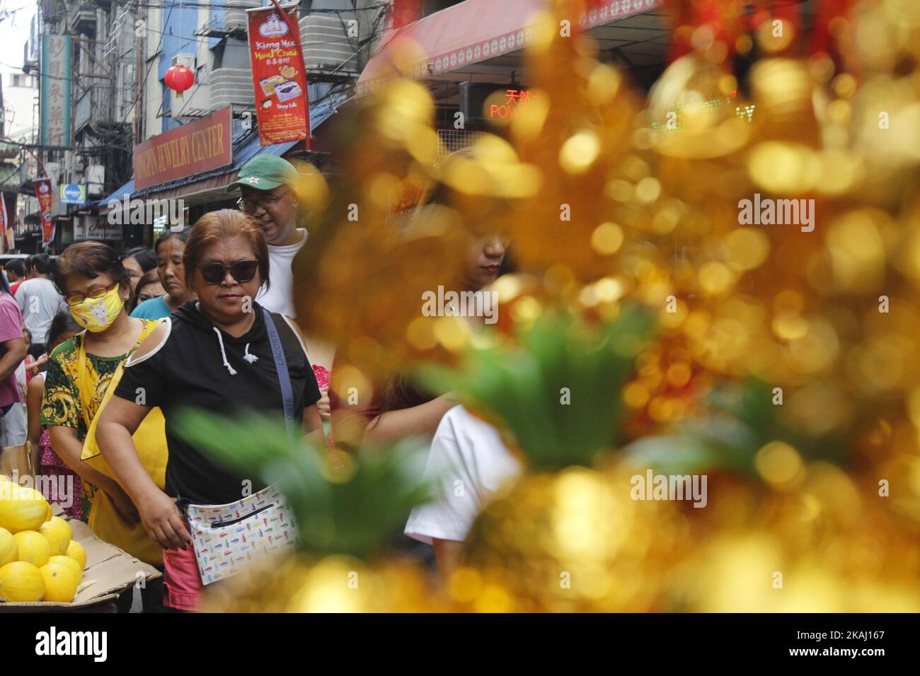 Locals look at products sold in Binondo Manila, Philippines on Chinese New Year, February 8, 2016.  A holiday in the Philippines, people celebrate the New Year in Binondo eating in authentic Chinese restaurants, buying lucky charms and watching dragon and lion dance as they welcome the Year of the Monkey. (Photo by Marlo Cueto/NurPhoto) *** Please Use Credit from Credit Field *** Stock Photo