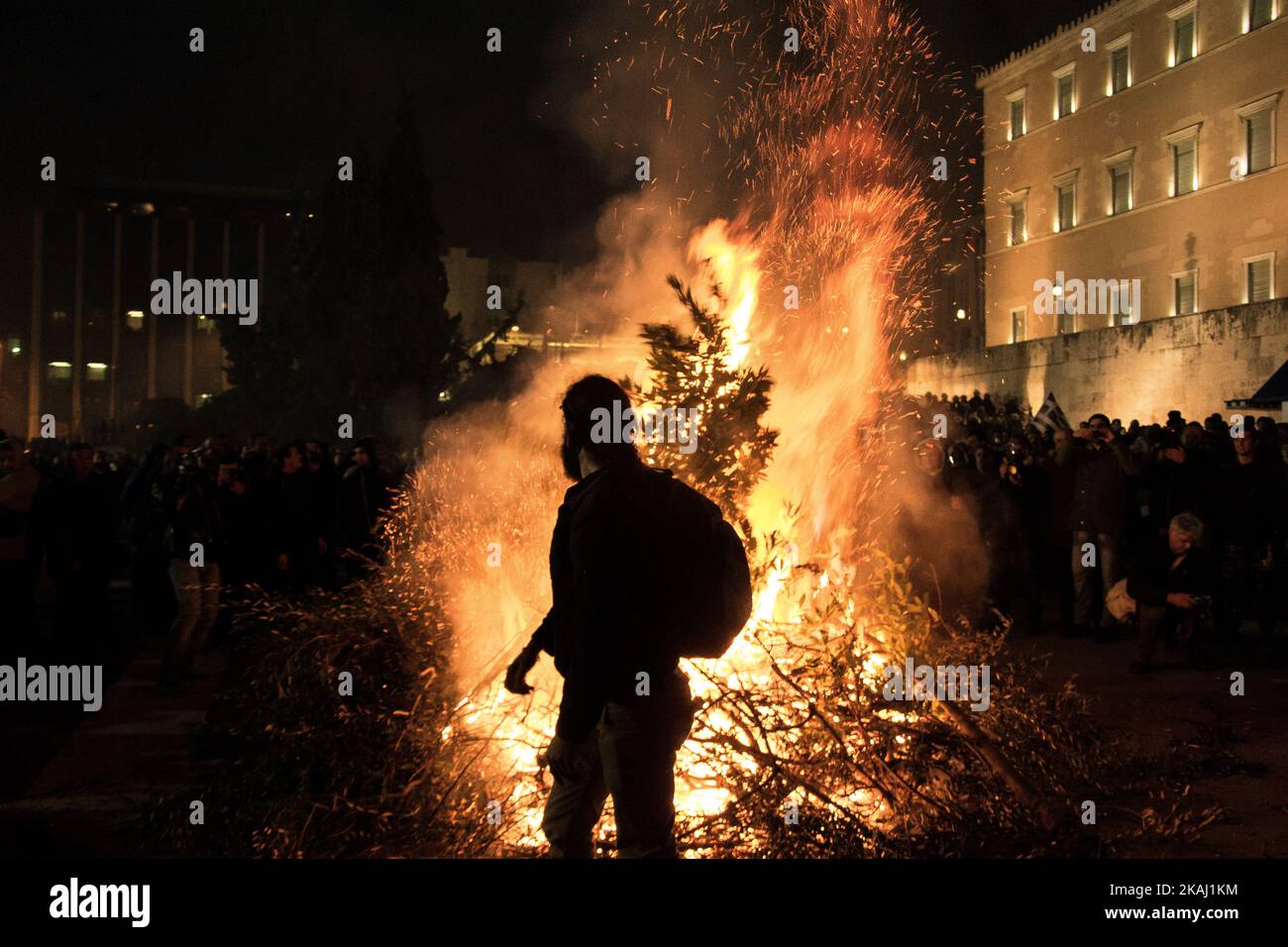 Farmers set fire in front of the Parliament building at Syntagma Square during a protest against pension reform. Greek farmers from across the country traveled to Athens on Friday, February 12,2016, in order to stage a two-day protest outside of the Parliament against the governmentâ€™s plans to impose tax rises and pension system reforms. (Photo by Chrissa Giannakoudi/NurPhoto) *** Please Use Credit from Credit Field *** Stock Photo