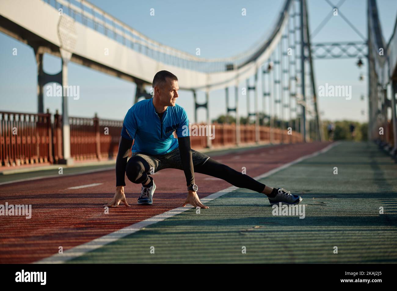 Middle age athlete doing warm-up exercise before starting running Stock ...