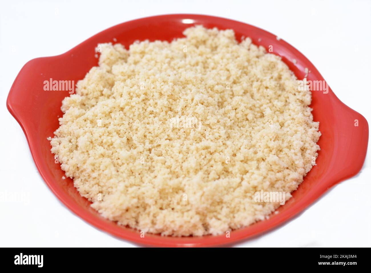 Arabian Cuisine dish of small steamed granules of rolled durum wheat semolina called Koskosi, couscous, kusksi or kseksu, popular in Morocco, Algeria, Stock Photo