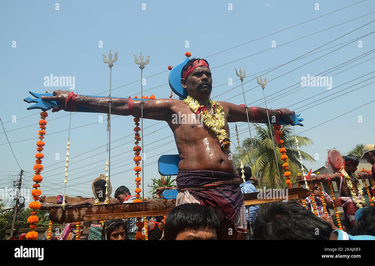 A Hindu devotee is pierced with nail to a cross during the annual Shiva