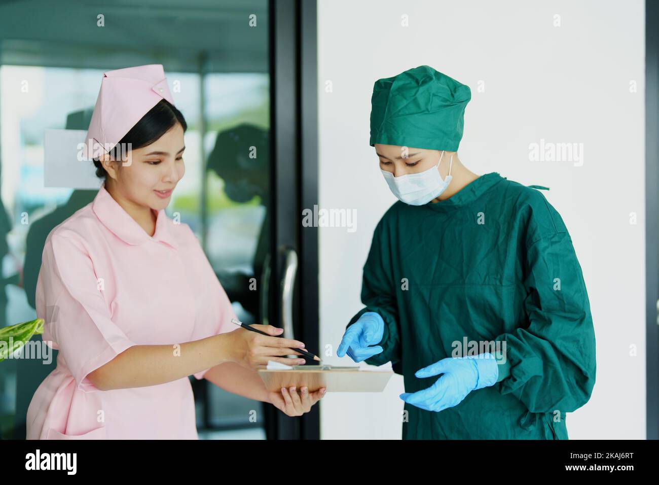doctor and nurse talking before going into the operating room Stock