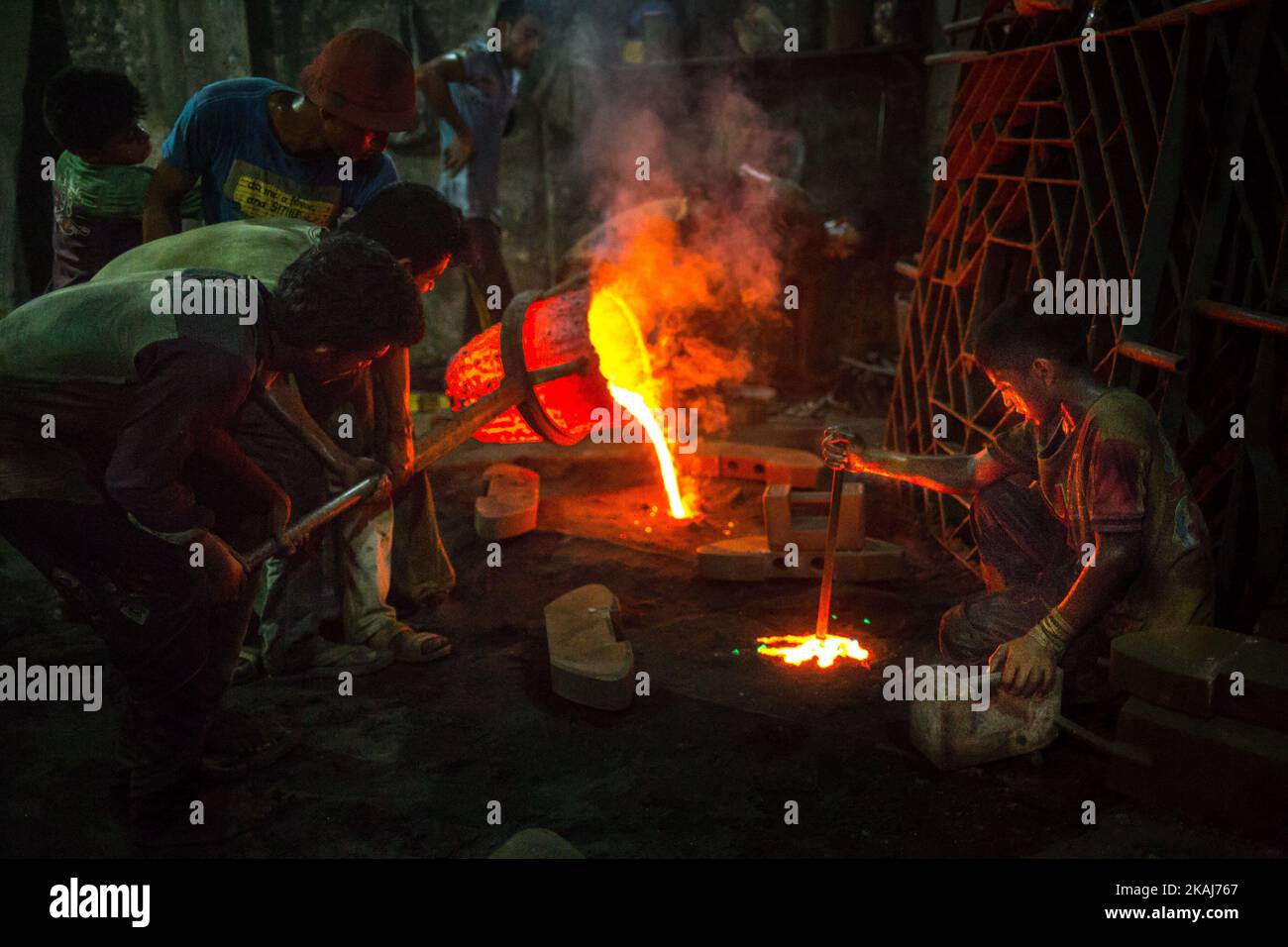 A boy is working in an extreme hot environment which is also dangerous. Ship building industry in Bangladesh spreading rapidly where workers from all ages work together, in Dhaka, Bangladesh, on April 28, 2016. The working condition here is serious and not suitable for any children. Conditions are hot and often dangerous. Even workers do not use minimum safety guard. Therefore accidents happen very frequently. Children who work here are growing up without education which has been leading them towards uncertain future. The reason of child labor in such dangerous working condition is cheap labor Stock Photo