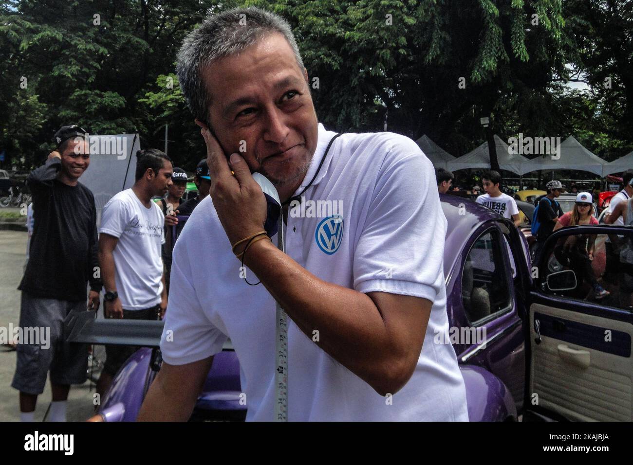 A Volkswagen enthusiast reacts as he measures the loudness of a Volkswagen during the celebration of World Volkswagen Day in Quezon City, east of Manila, Philippines on Sunday, 19 June 2016. World Volkswagen Day is celebrated every June 22 or its nearest Sunday. (Photo by Richard James Mendoza/NurPhoto) *** Please Use Credit from Credit Field *** Stock Photo