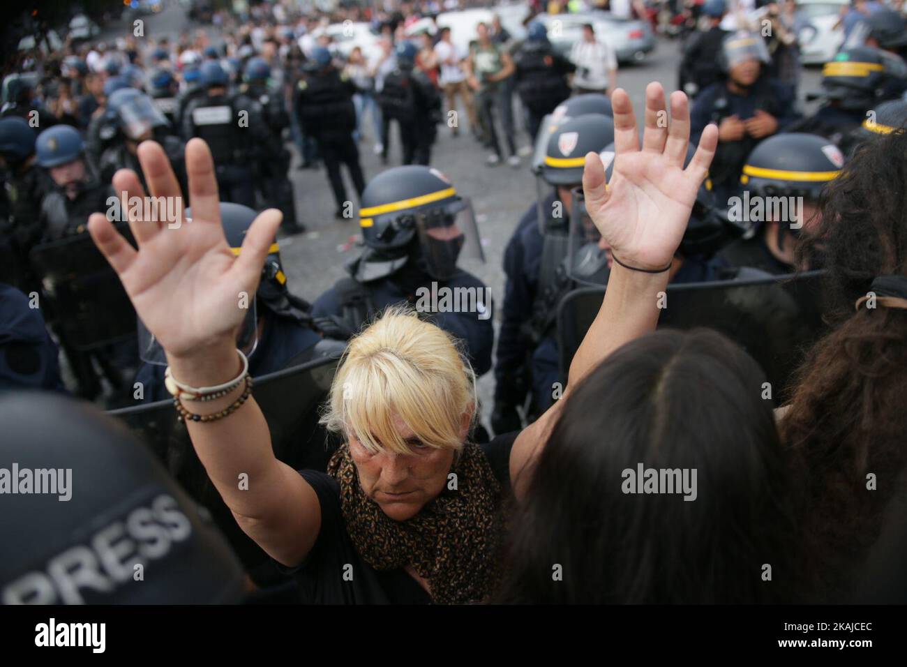 A woman Rise up her hands during the encapsulation of riot police next to la Bastille, CGT unionists Marched against Labour law this Wednesday, 23 June 2016 in Paris, next to the Place of La Bastille. Today's march will be the 10th in a wave of protests against the government's disputed labour reforms that kicked off in March, with many descending into violence, notably in Paris and the western cities of Nantes and Rennes.  (Photo by Emilio Espejel/NurPhoto) *** Please Use Credit from Credit Field *** Stock Photo