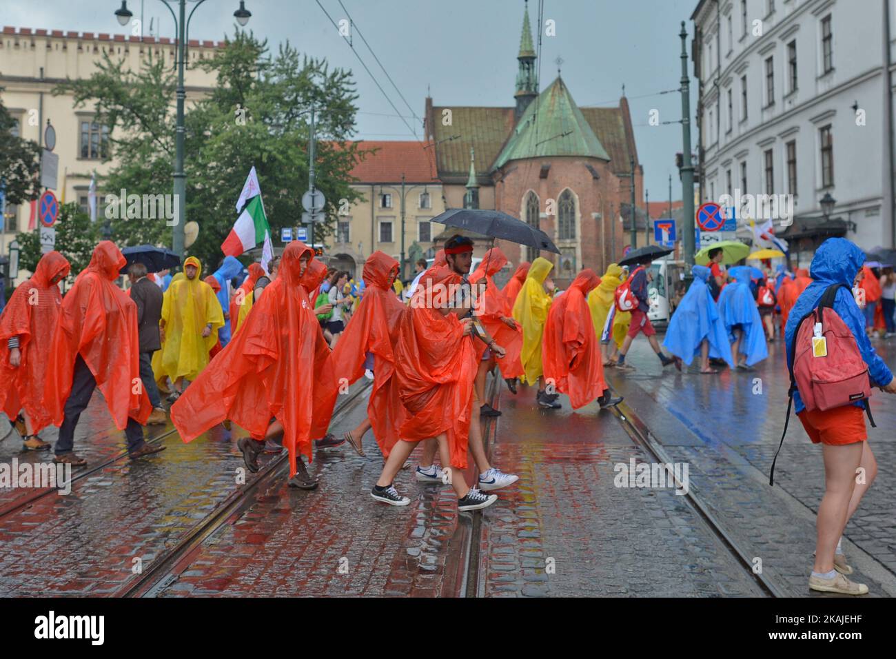 Pilgrims from all around the world surprised by a rain in the center of Krakow ahead  of the official opening Mass and the World Youth Day 2016 in Blonia Park in Krakow  On Tuesday, 26 July 2016, in Krakow, Poland.               Photo by Artur Widak *** Please Use Credit from Credit Field *** Stock Photo