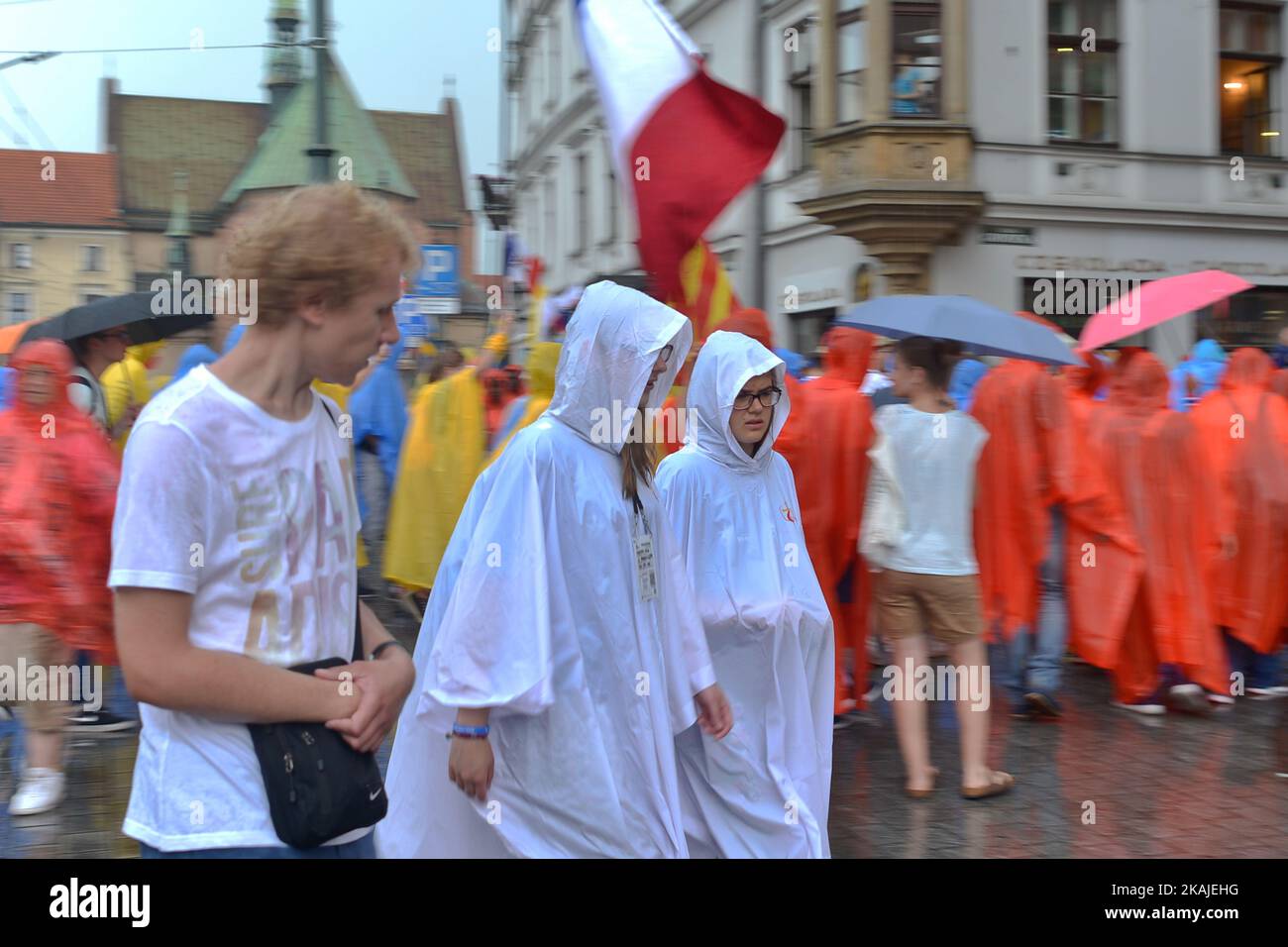 Pilgrims from all around the world surprised by a rain in the center of Krakow ahead  of the official opening Mass and the World Youth Day 2016 in Blonia Park in Krakow  On Tuesday, 26 July 2016, in Krakow, Poland.               Photo by Artur Widak *** Please Use Credit from Credit Field *** Stock Photo