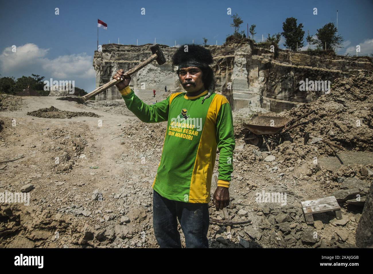 A man pose after breaking stone breccia in Sambirejo, Yogyakarta ...