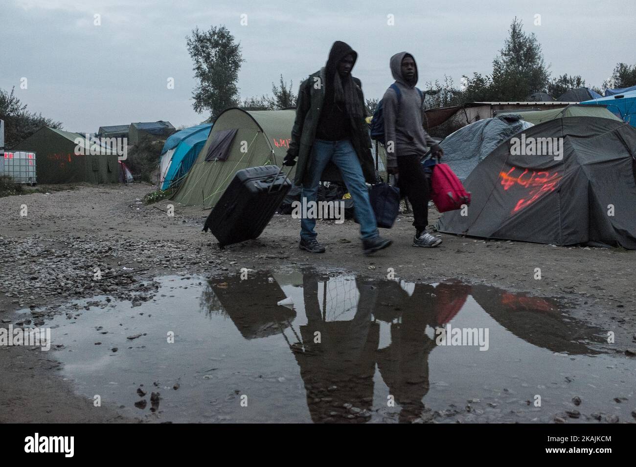 Two Migrants leave the Calais Jungle. The refugee camp on the coast to the English Channel is to be cleared today. The approximately 8,000 refugees are distributed after the registration by busses to various reception centers in France. (Photo by Markus Heine/NurPhoto) *** Please Use Credit from Credit Field *** Stock Photo