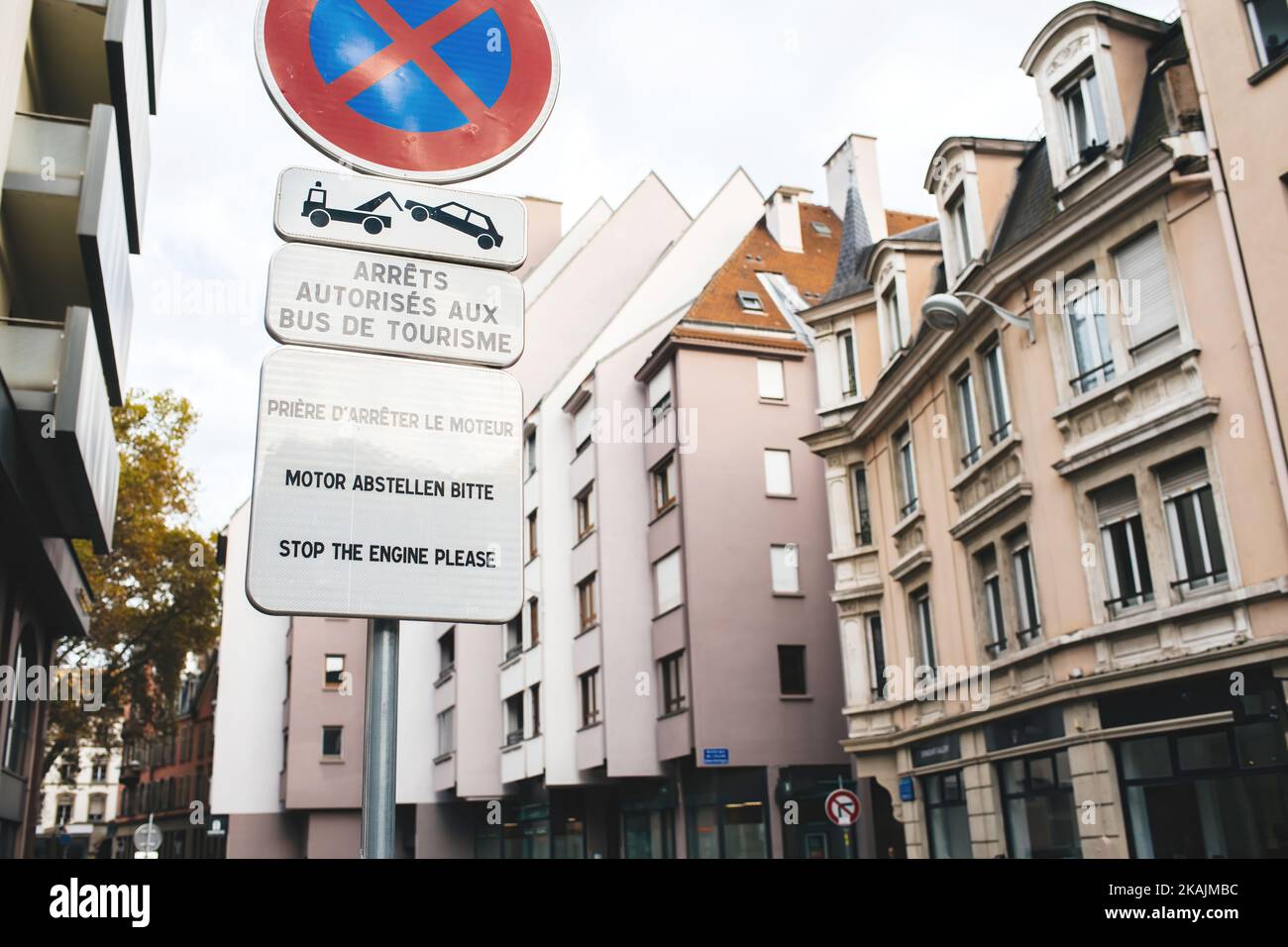 Street transportation sign in French city with special dedicated area for bus drivers only - stop the engine please in French German and English Stock Photo