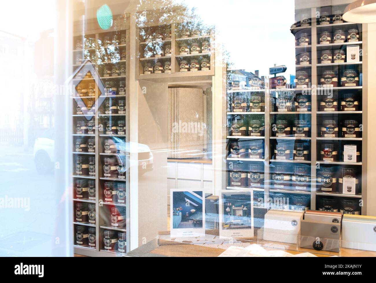 Strasbourg, France - Oct 28, 2022: Tens of Farrow and Ball luxury British paint in the branded store - British manufacturer of paints and wallpapers largely based upon historic colour palettes and archives - car reflected in showcase Stock Photo