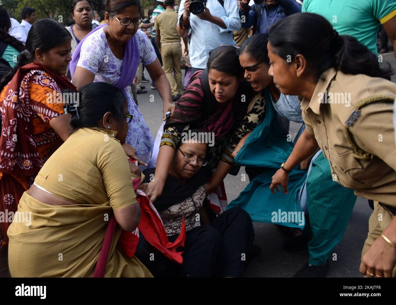 Indian police officials detain the activist of Socialist Unity Center of India-Marxist (SUCI-M) during the protest against child trafficking in West Bengal in Kolkata , India on Tuesday , 29th November , 2016. Several senior doctors and nursing homes in various districts of West Bengal were under the scanner of CID probing into the child trafficking racket unearthed from North 24 Parganas district's Baduria. (Photo by Sonali Pal Chaudhury/NurPhoto) *** Please Use Credit from Credit Field *** Stock Photo