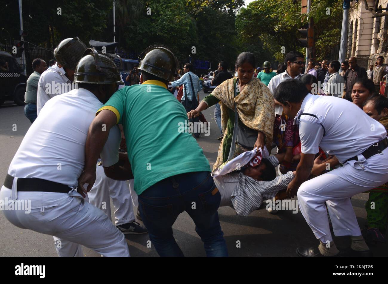 Indian police officials detain the activist of Socialist Unity Center of India-Marxist (SUCI-M) during the protest against child trafficking in West Bengal in Kolkata , India on Tuesday , 29th November , 2016. Several senior doctors and nursing homes in various districts of West Bengal were under the scanner of CID probing into the child trafficking racket unearthed from North 24 Parganas district's Baduria. (Photo by Sonali Pal Chaudhury/NurPhoto) *** Please Use Credit from Credit Field *** Stock Photo
