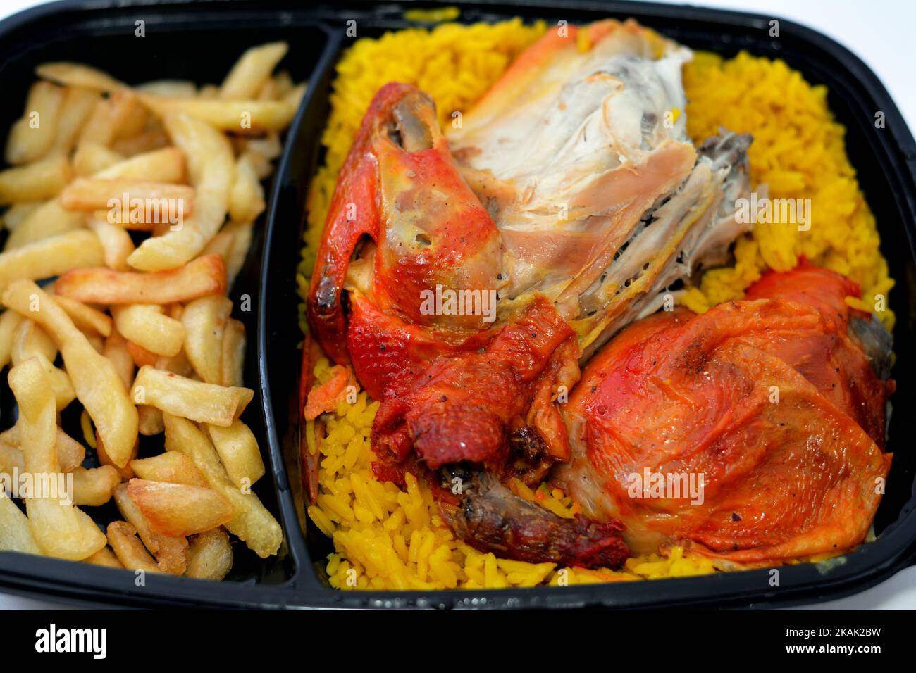 Chicken mandi kabsa with long basmati rice and french fries, served