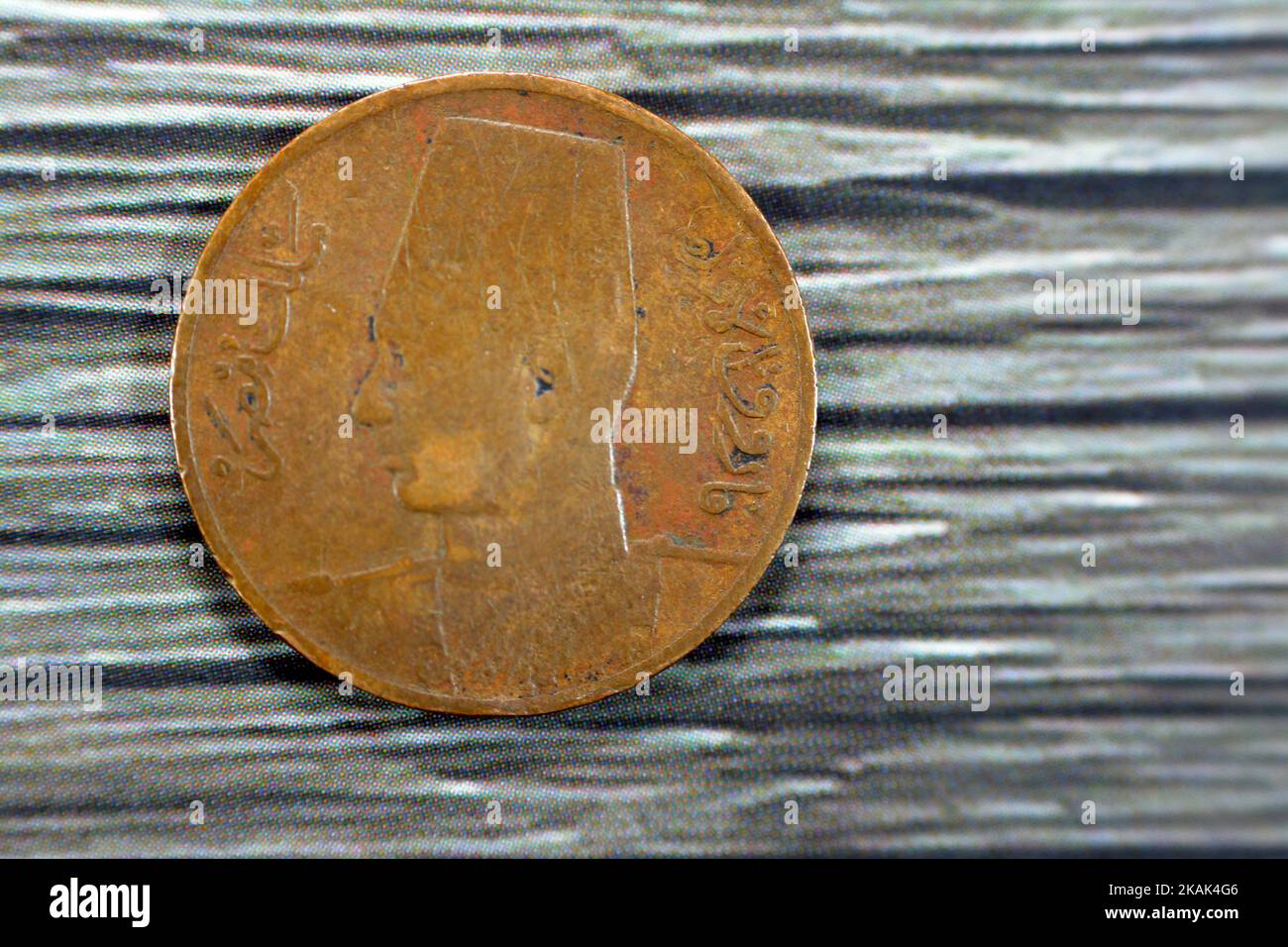 Obverse side of an old 1 One Egyptian red millieme year 1950 features Portrait of King Farouk the 1st facing left, wearing fez, the currency of kingdo Stock Photo