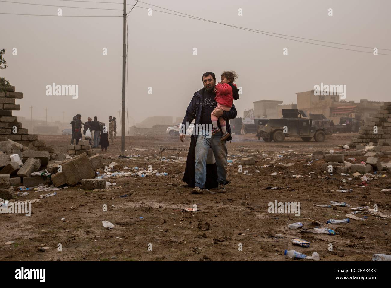 (12/2/2016) Ali Ahmed and his family reach the liberated district of Hay Samah, on the eastern outskirts of Mosul / Iraq after a power-taking escape from the combat area. (Photo by Sebastian Backhaus/NurPhoto) *** Please Use Credit from Credit Field *** Stock Photo