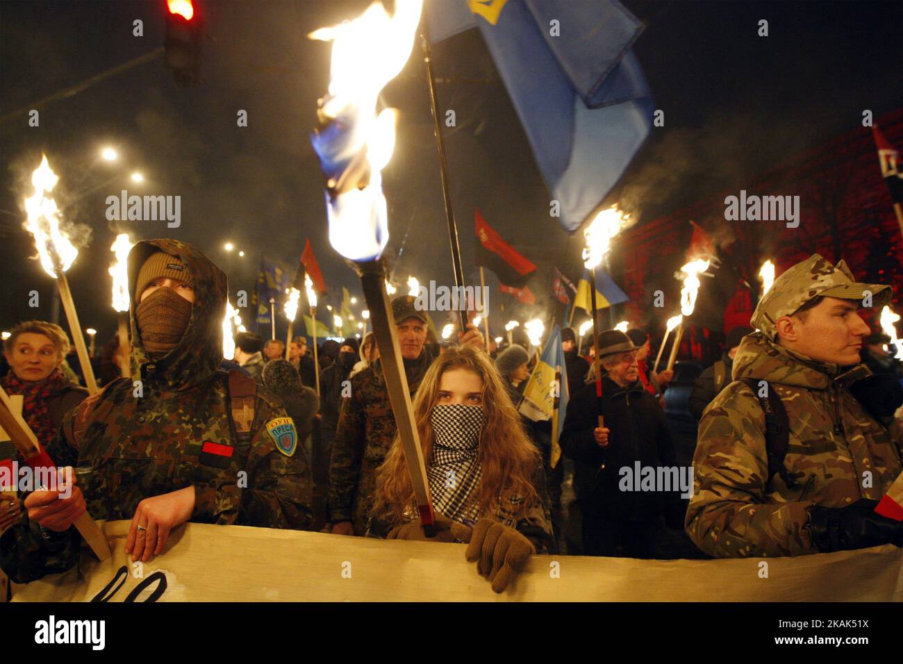 Ukrainian nationalists carry torches and banner with Bandera and ...