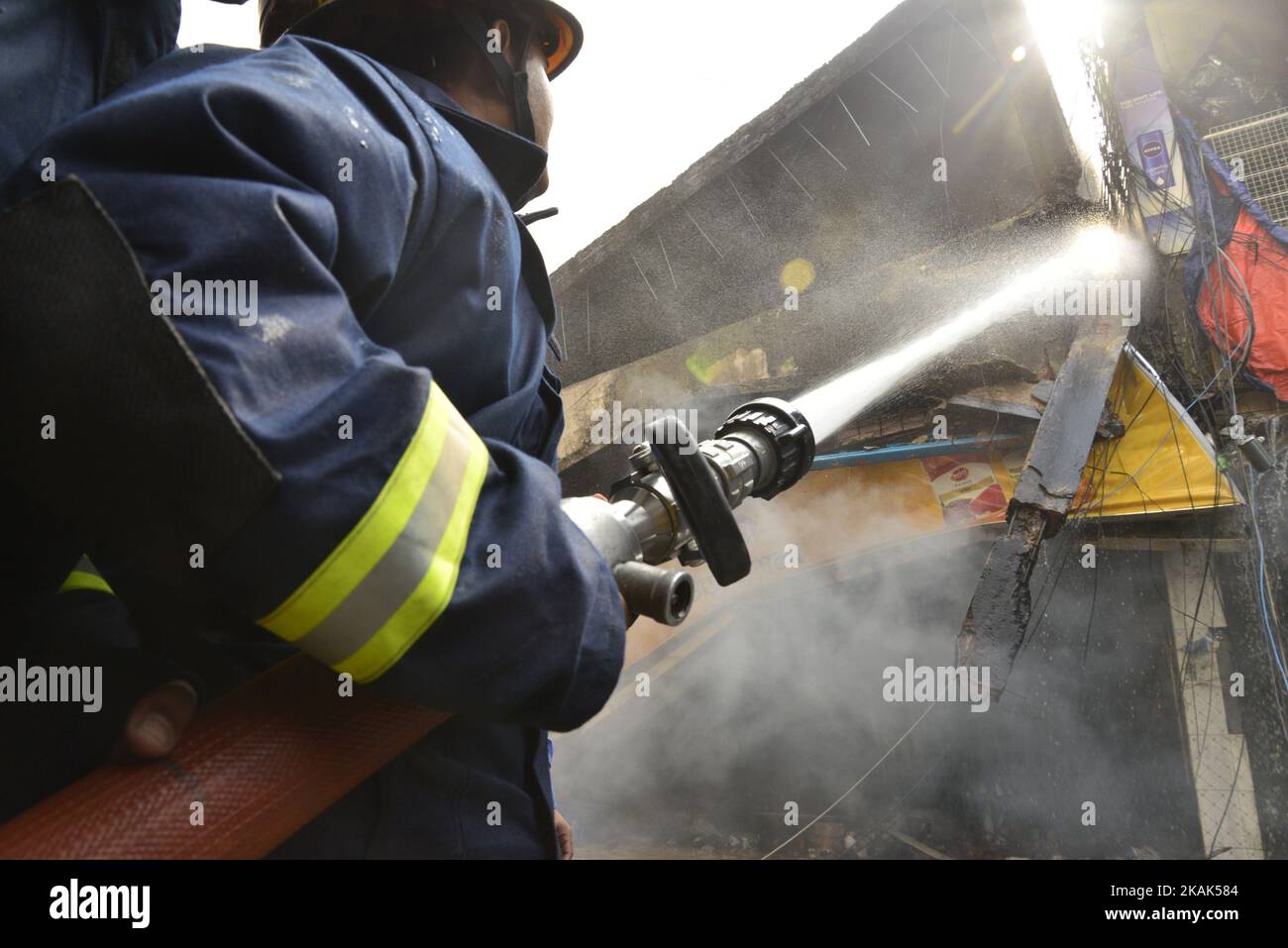 Bangladeshi firefighters try to douse flame after a fire broke out in a ...