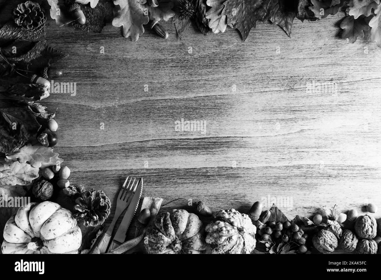 Thanksgiving pumpkins with fruits and falling leaves on rustic wooden ...
