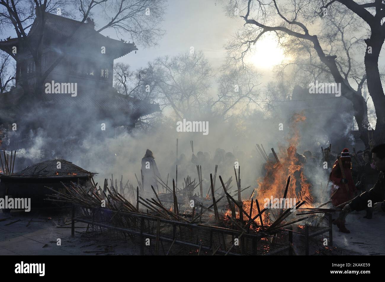 Chinese worshippers light incense as they pray at the Dacheng Temple on ...