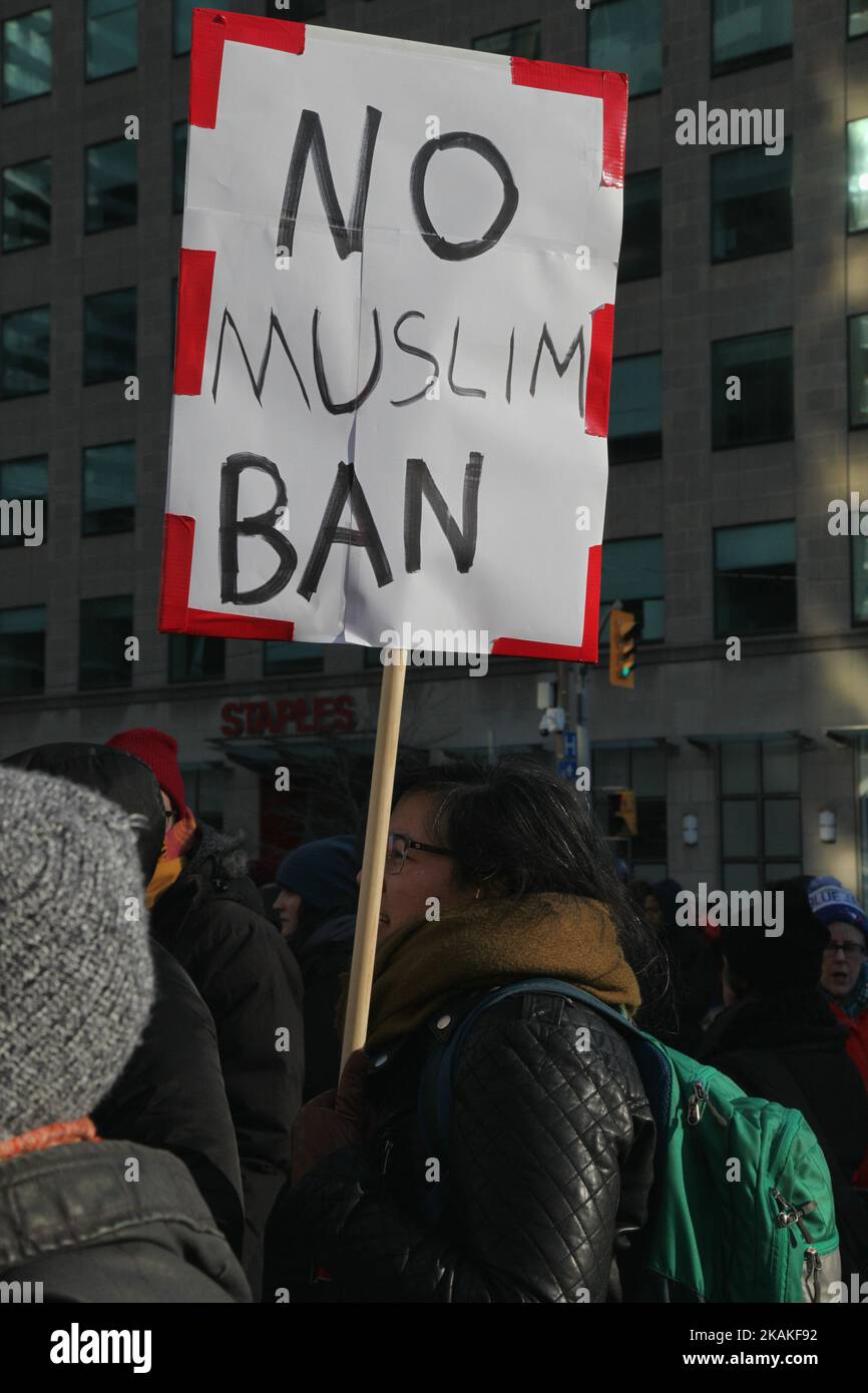 Man holds a sign saying 'no Muslim ban' during a massive protest against President Trump's travel ban outside of the U.S. Consulate in downtown Toronto, Ontario, Canada, on January 30, 2017. Canadians joined countries around the world in protesting against American President Donald Trump's executive order, banning citizens of seven majority Muslim countries (Iran, Iraq, Sudan, Somalia, Syria, Yemen and Libya) from entering the United States for the next three months and banning Syrian refugees from indefinitely entering America. (Photo by Creative Touch Imaging Ltd./NurPhoto) *** Please Use Cr Stock Photo