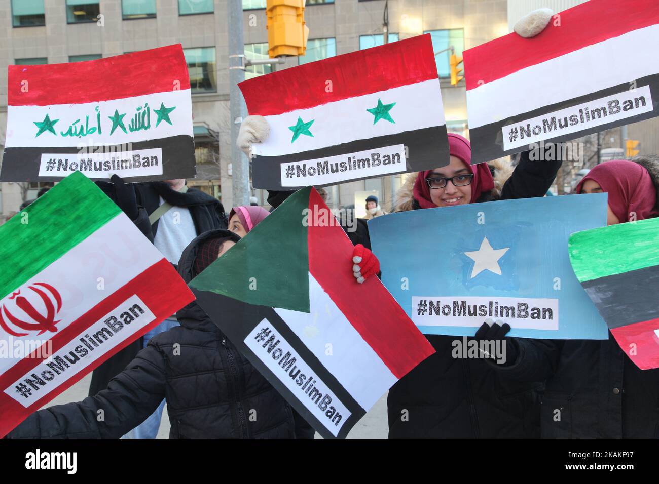Muslim women hold signs with the flags of the banned countries during a massive protest against President Trump's travel ban outside of the U.S. Consulate in downtown Toronto, Ontario, Canada, on January 30, 2017. Canadians joined countries around the world in protesting against American President Donald Trump's executive order, banning citizens of seven majority Muslim countries (Iran, Iraq, Sudan, Somalia, Syria, Yemen and Libya) from entering the United States for the next three months and banning Syrian refugees from indefinitely entering America. (Photo by Creative Touch Imaging Ltd./NurP Stock Photo