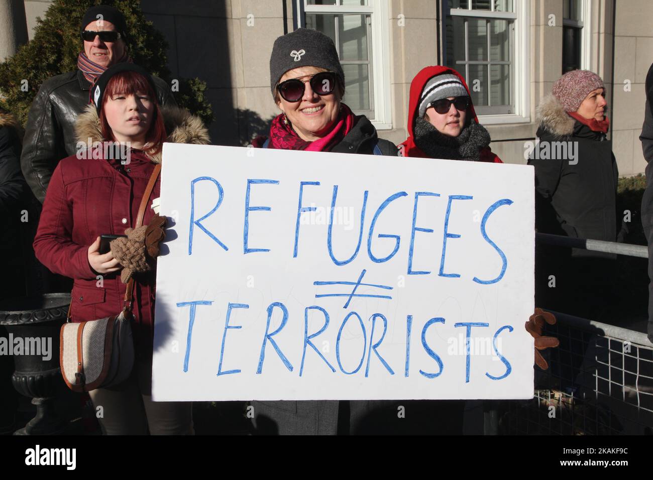 Woman holds a sign saying 'refugees do not equal terrorists' during a massive protest against President Trump's travel ban outside of the U.S. Consulate in downtown Toronto, Ontario, Canada, on January 30, 2017. Canadians joined countries around the world in protesting against American President Donald Trump's executive order, banning citizens of seven majority Muslim countries (Iran, Iraq, Sudan, Somalia, Syria, Yemen and Libya) from entering the United States for the next three months and banning Syrian refugees from indefinitely entering America. (Photo by Creative Touch Imaging Ltd./NurPho Stock Photo